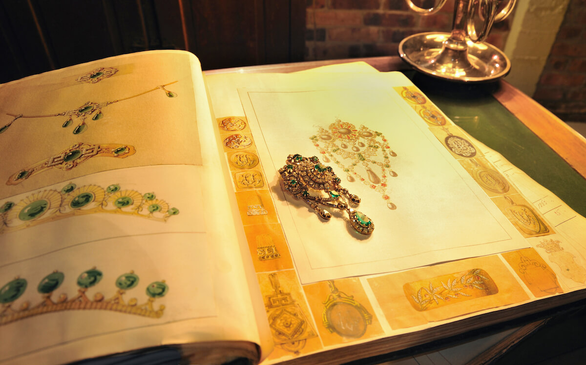 Emerald and diamond brooch (approx. 1850, Mellerio Collection) and design book (approx. 1850) in the Archives 9, rue de la Paix, Paris. Courtesy of Mellerio.