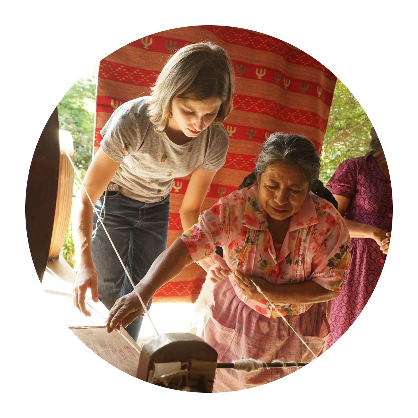 Leonor Lazo demonstrating how to use the spool, courtesy of Dixza Rugs and Organic Farm